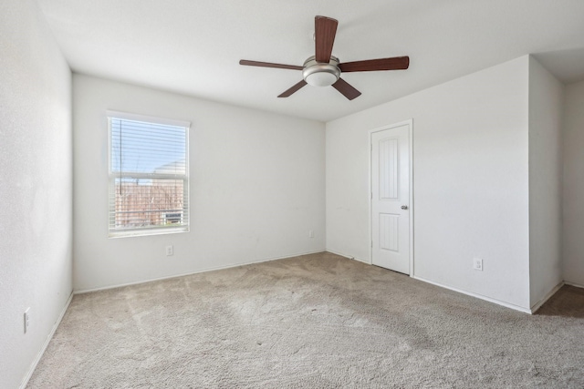 empty room featuring light carpet and ceiling fan