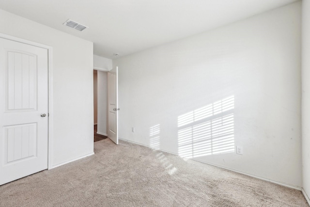 unfurnished bedroom featuring light carpet