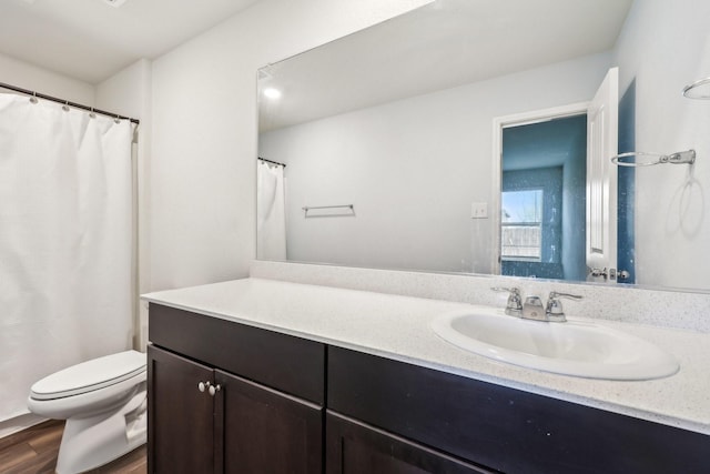 bathroom with vanity, hardwood / wood-style floors, and toilet