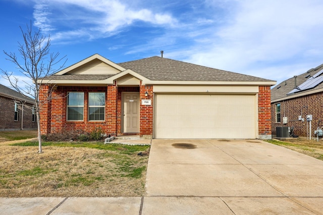 ranch-style home featuring central AC unit and a garage