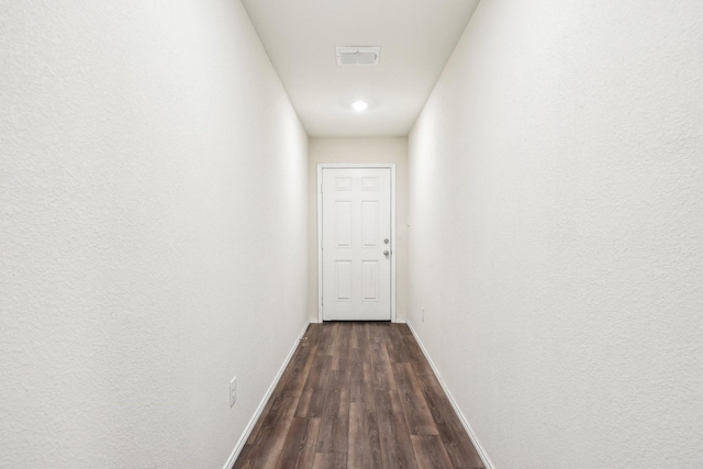 corridor featuring dark hardwood / wood-style flooring