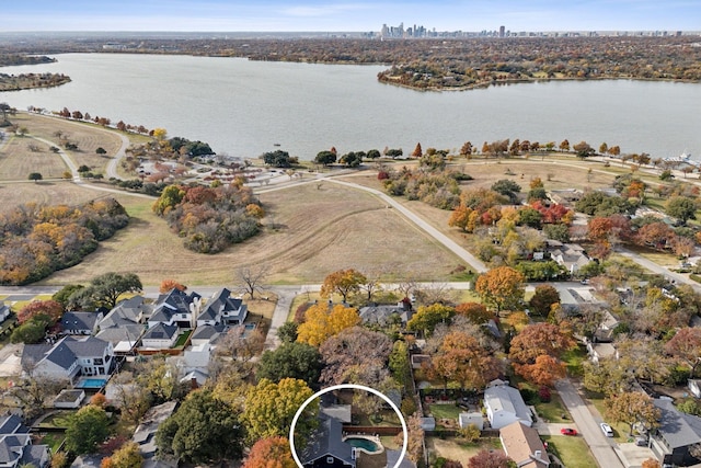 drone / aerial view featuring a residential view and a water view