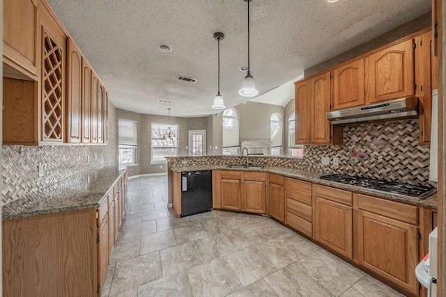 kitchen featuring pendant lighting, sink, dishwasher, stone counters, and stainless steel gas cooktop