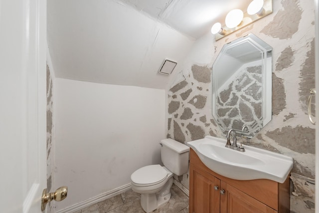 bathroom with vanity, tile patterned floors, lofted ceiling, and toilet