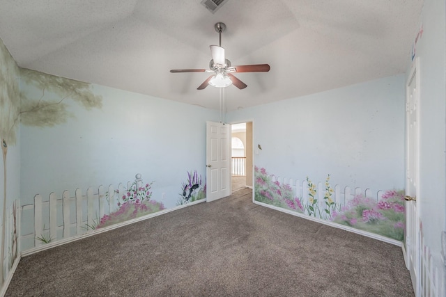 carpeted empty room with a textured ceiling and ceiling fan