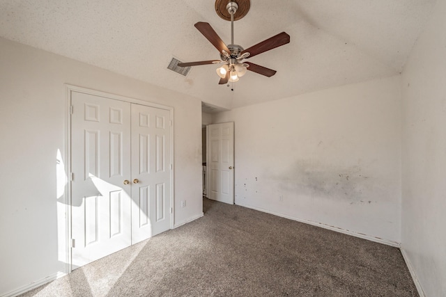 unfurnished bedroom with carpet, ceiling fan, and a closet