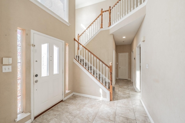 entrance foyer featuring a towering ceiling and a wealth of natural light