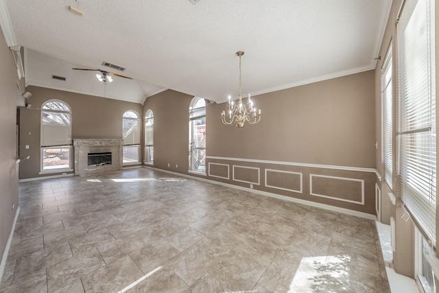 unfurnished living room featuring crown molding, a notable chandelier, a fireplace, a textured ceiling, and vaulted ceiling