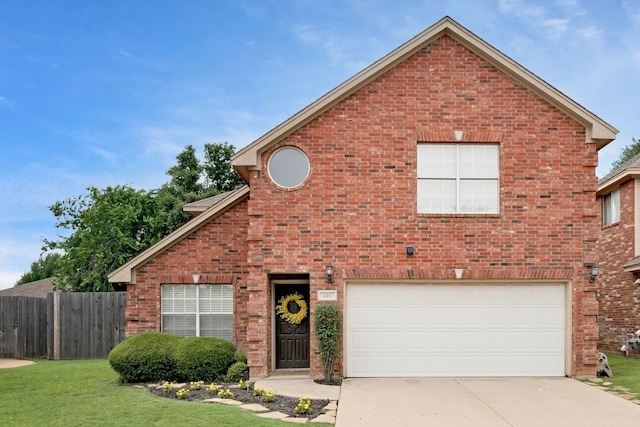 view of front property with a garage and a front yard