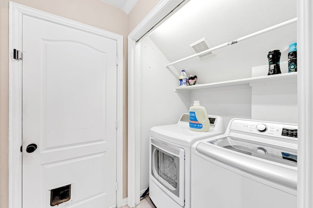 laundry area with washing machine and dryer