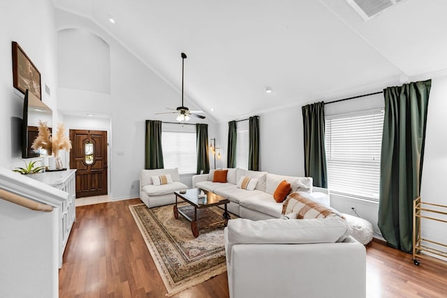 living room with ceiling fan, high vaulted ceiling, and hardwood / wood-style floors