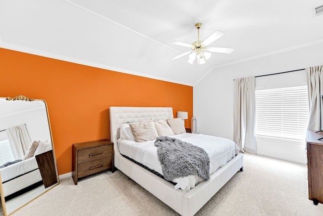 bedroom with ceiling fan, light colored carpet, lofted ceiling, and ornamental molding