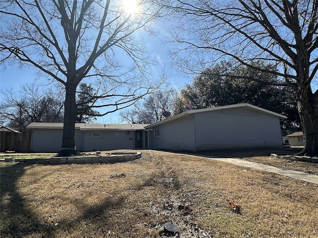 view of side of home with a yard