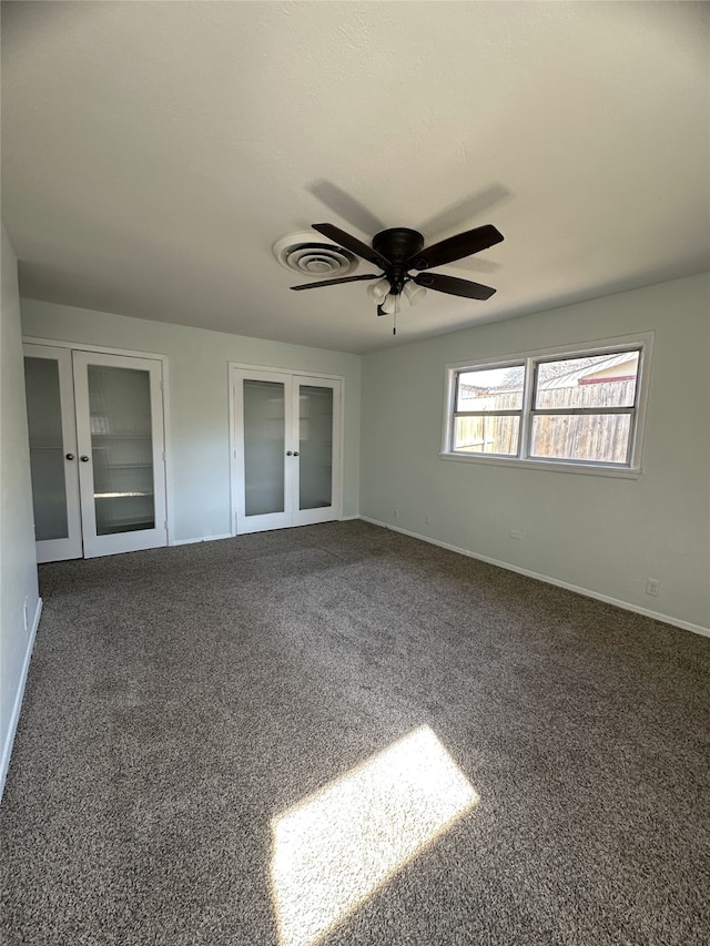 unfurnished bedroom with french doors, ceiling fan, and dark colored carpet