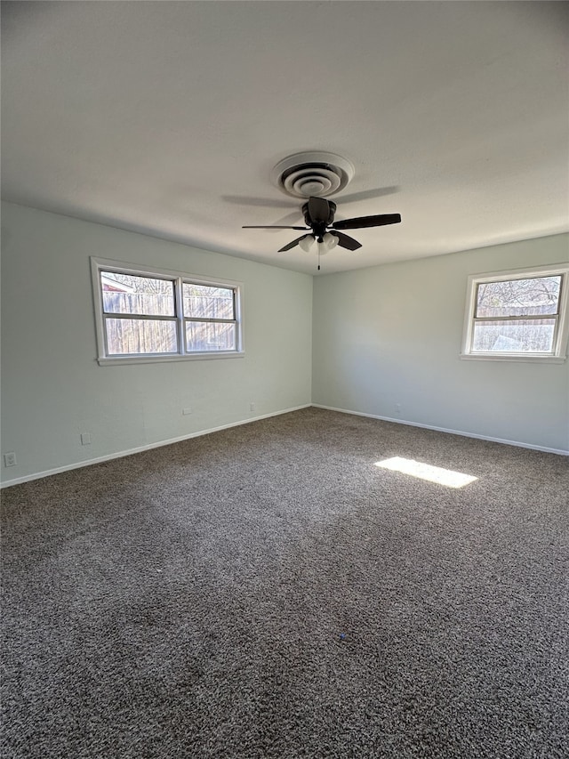 spare room featuring carpet floors, plenty of natural light, and ceiling fan