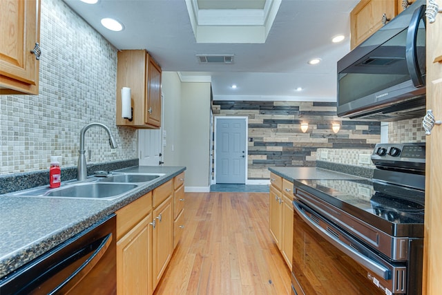 kitchen featuring sink, decorative backsplash, black appliances, crown molding, and light wood-type flooring