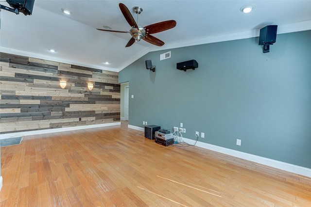 unfurnished living room with crown molding, light hardwood / wood-style flooring, and wood walls