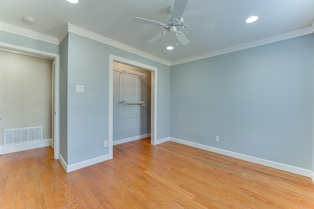 unfurnished bedroom with crown molding, a closet, ceiling fan, and light hardwood / wood-style flooring