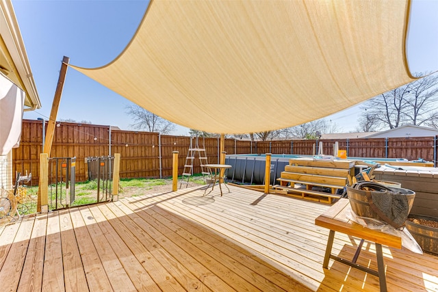 wooden deck with a fenced in pool