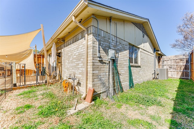 view of home's exterior featuring cooling unit and a lawn