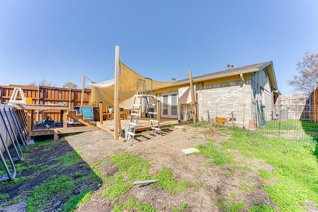 rear view of house with a wooden deck