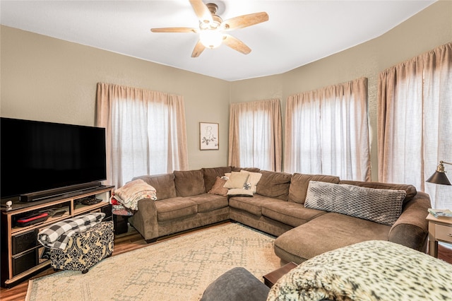 living room with a ceiling fan and wood finished floors