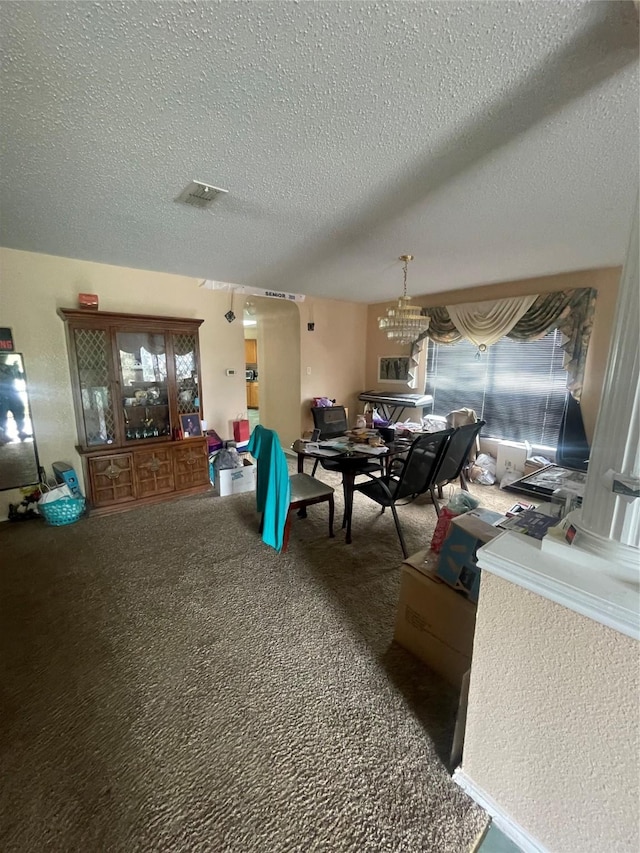 dining area featuring carpet flooring and a textured ceiling