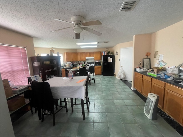 dining room featuring ceiling fan and a textured ceiling