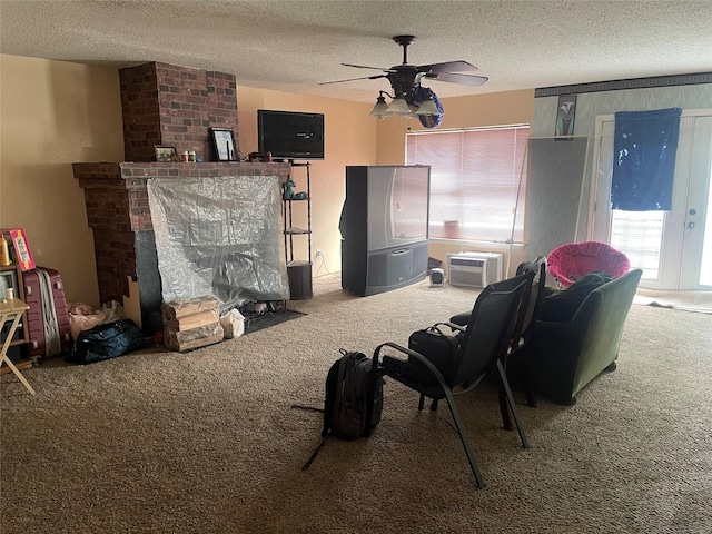 living room with a fireplace, carpet flooring, and a textured ceiling