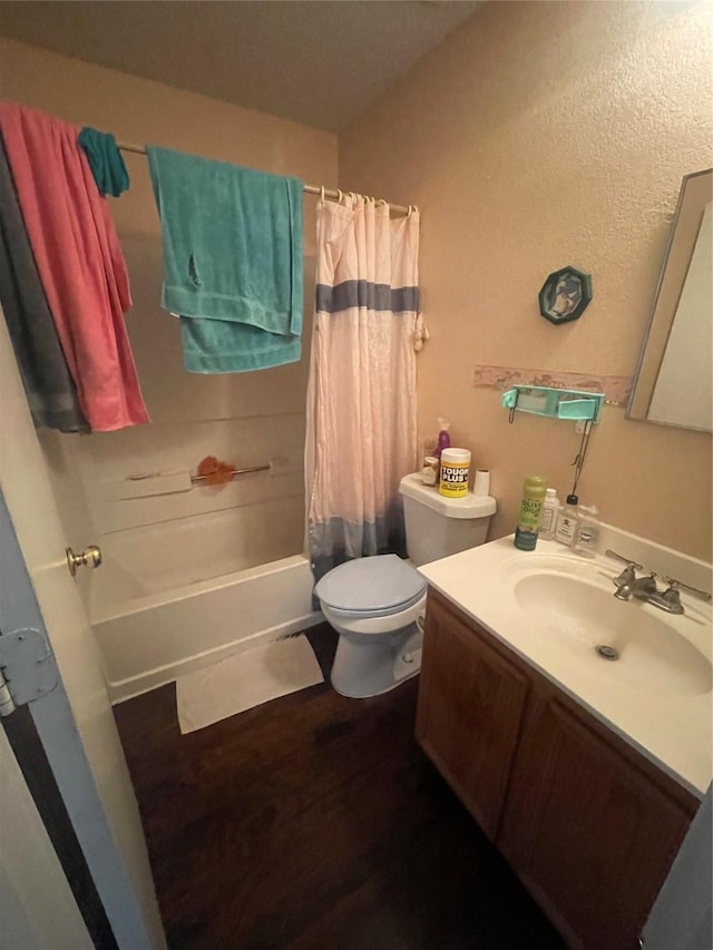 full bathroom featuring hardwood / wood-style flooring, vanity, toilet, and shower / bath combo with shower curtain