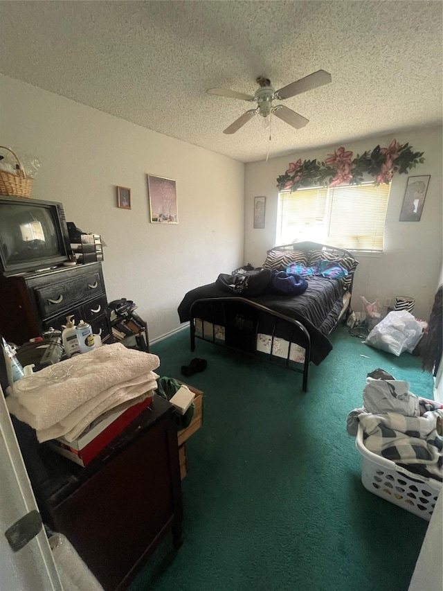 bedroom with ceiling fan, carpet, and a textured ceiling