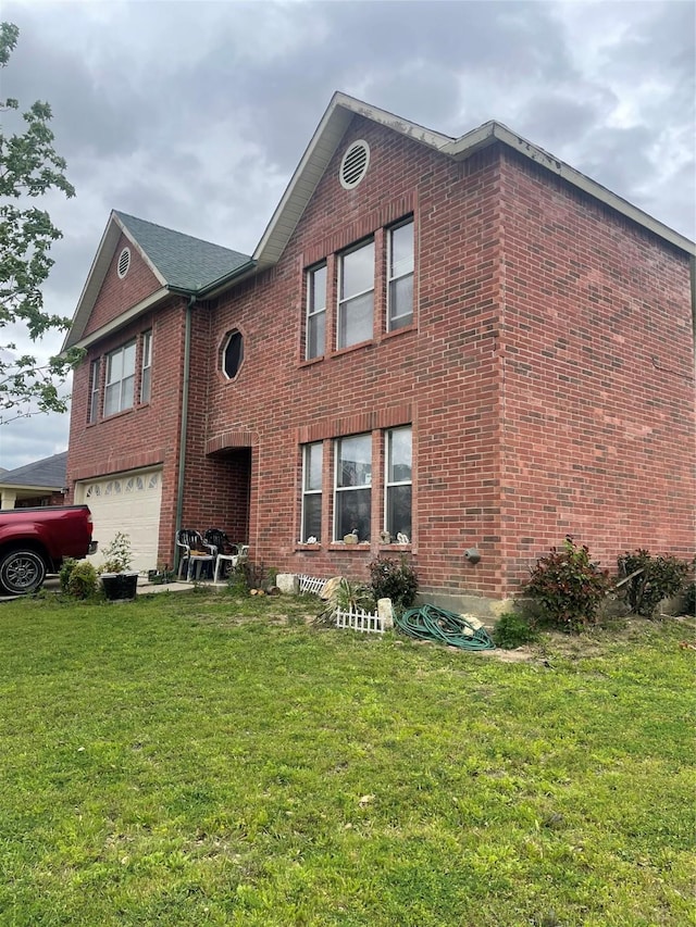 exterior space with a garage and a yard