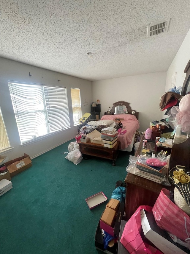 carpeted bedroom with a textured ceiling