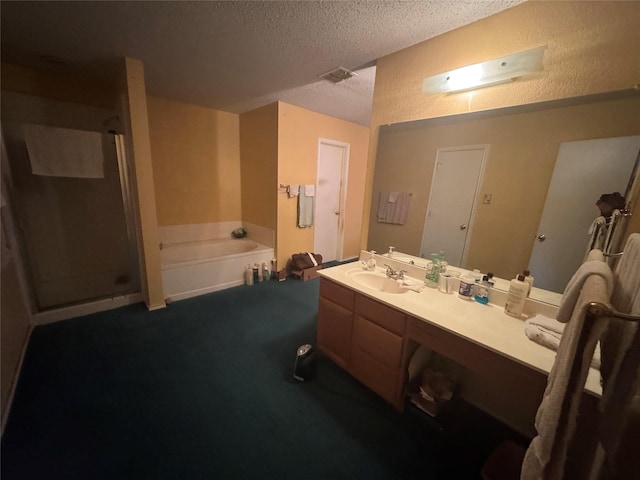 bathroom with vanity, plus walk in shower, and a textured ceiling