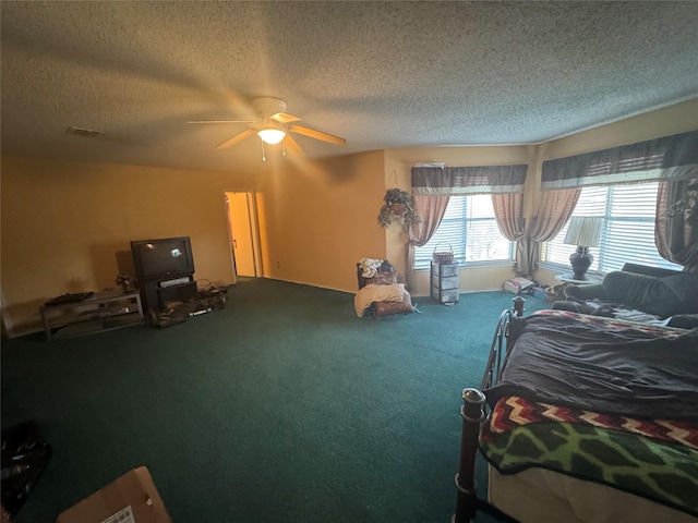 bedroom featuring carpet flooring, a textured ceiling, and ceiling fan