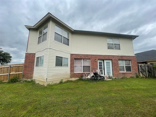 rear view of house with a lawn