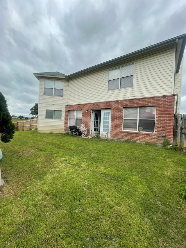 back of house with a lawn