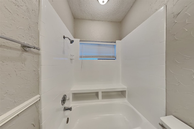 bathroom with toilet, a textured ceiling, and  shower combination