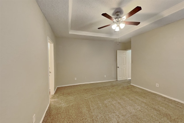 carpeted spare room featuring ceiling fan, a raised ceiling, and a textured ceiling