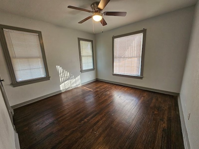 empty room featuring ceiling fan and dark hardwood / wood-style floors