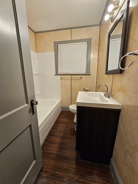 full bathroom featuring vanity, toilet, shower / washtub combination, and wood-type flooring