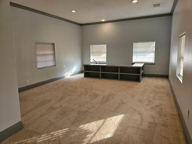 carpeted empty room featuring crown molding