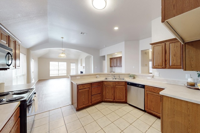 kitchen featuring pendant lighting, black appliances, kitchen peninsula, and lofted ceiling