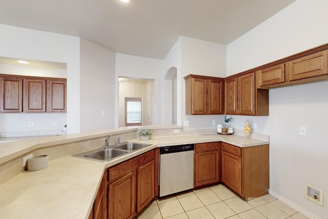 kitchen with dishwasher, sink, and light tile patterned flooring