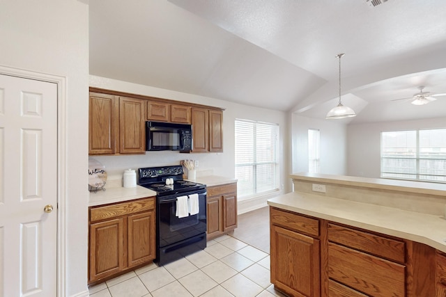 kitchen featuring light tile patterned floors, ceiling fan, hanging light fixtures, black appliances, and vaulted ceiling