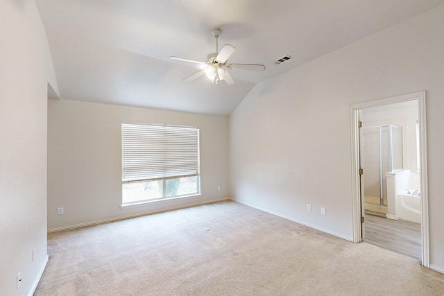 empty room with ceiling fan, light colored carpet, and lofted ceiling