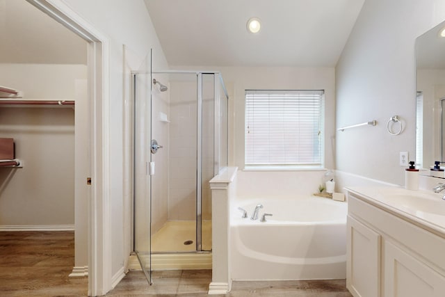 bathroom with hardwood / wood-style flooring, vanity, and shower with separate bathtub