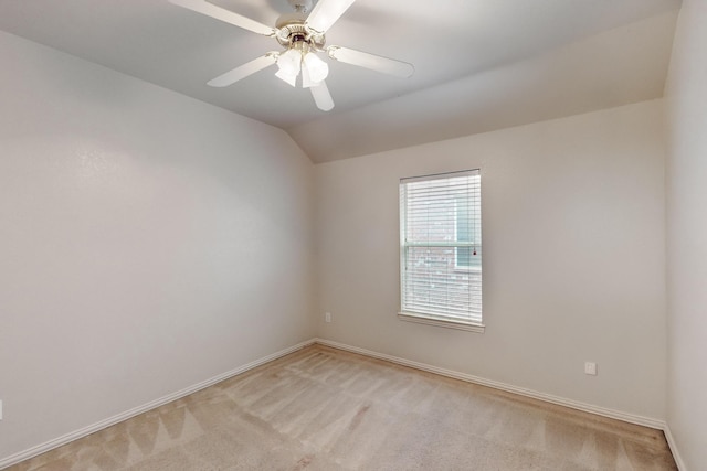 carpeted spare room with lofted ceiling and ceiling fan