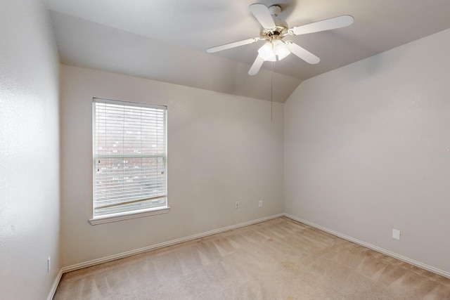 carpeted spare room with vaulted ceiling and ceiling fan