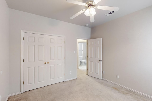 unfurnished bedroom featuring light colored carpet, ceiling fan, and a closet